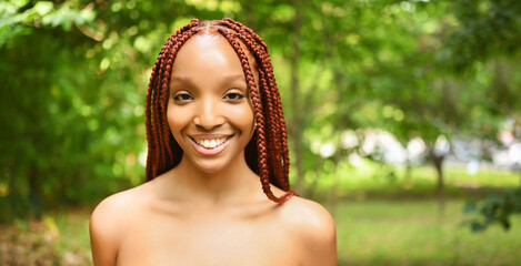 Close up portrait Beautiful young African American woman with red braids hair, perfect white teeth...