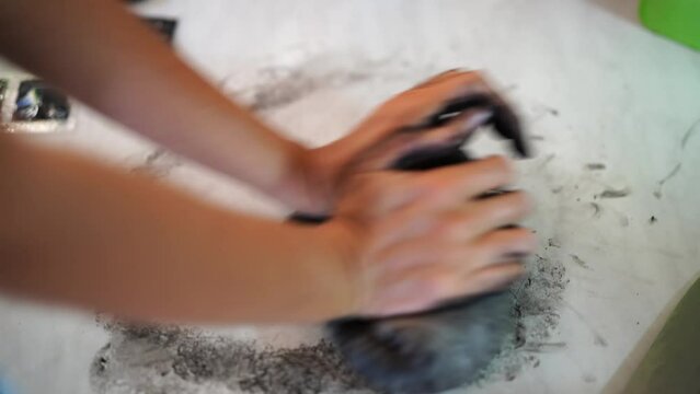 Cook kneading black dough with cuttlefish ink. High quality 4k footage