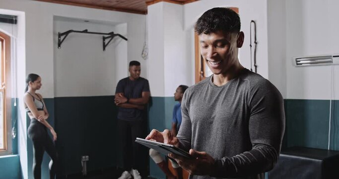 Man using a tablet in gym, sharing fitness event fun