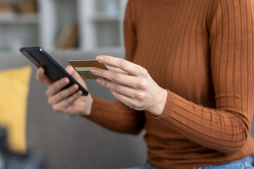 Online shopping with credit card and smartphone close-up
