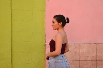 Modelo de perfil de chica hermosa en camisa ocre bien vestida con cabello recogido