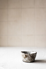 Japanese whiskey, SAKE/tea in a small ceramic cup on a white background with a place for text. Japanese style. Wabi-sabi.