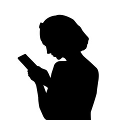 Silhouette of a girl looking into a mobile phone - 764187723