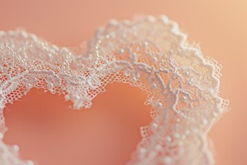 a delicate lace heart on a peach background, perfect for wedding stationery or a lingerie boutique