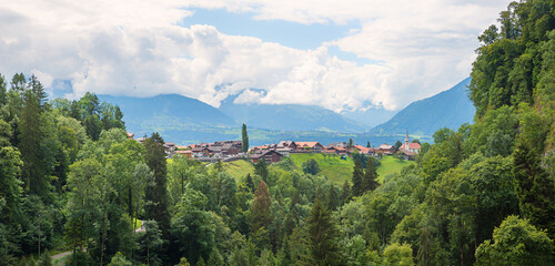 view to Sigriswil tourist resort and cloudy Bernese Alps landscape