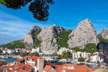 Scenic view of coastal town Omis surrounded by Dinara mountains in Split-Dalmatia, South Croatia,...