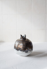 Ceramic pomegranate on a white background