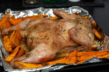 Chicken baked in spices with sweet potato slices