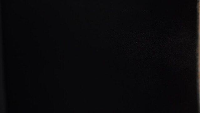 Cocoa powder floating in the air against black background