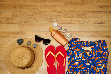 goodbye or hello summer concept, sunglasses and hat and slipper and maxi dress, cream sun bottle...