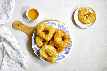 traditional Algerian fried baked donuts or pancake named Sfenj with honey bowl