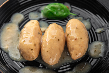 quenelles pork mushroom sauce canned food jar put food on a plate eating cooking appetizer meal food snack on the table copy space food background