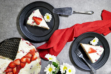 strawberry cake or Fraisier in french language in black plate  on grunge gray background 