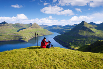 Tourist at Hvithamar Hill Top With Funningsfjordur Fjord View, Faroe Islands