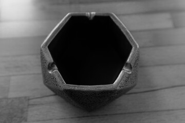 Monochrome , edge hexagon  shape, empty black ashtray. Minimalist,  table decoration.