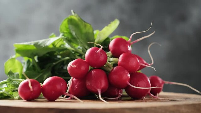 Fresh red radish bunch on a wooden cutting board, stock footage video 4k