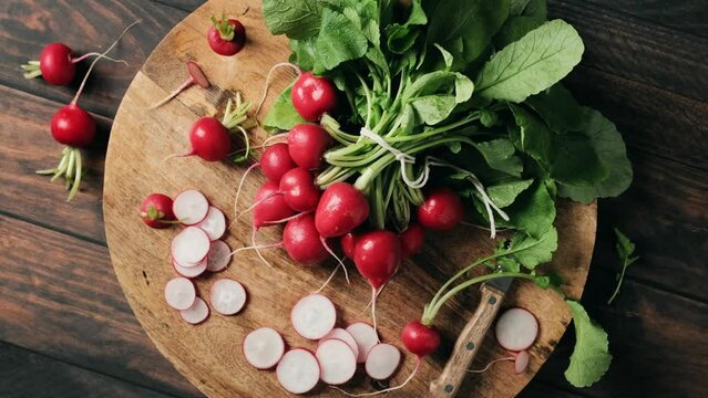 Fresh red radish bunch on a wooden cutting board, stock footage video 4k