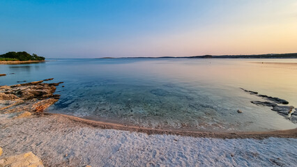 Beautiful sunset at pebble beach in coastal town Medulin, Istria peninsula, Croatia, Europe....