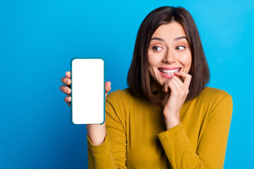 Photo of cunning funky woman wear shirt showing looking modern gadget empty space isolated blue...