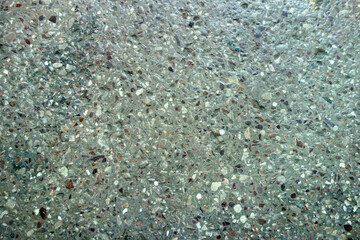 Old sanded concrete floor with a pebble structure used in industrial premises, factories and staircases