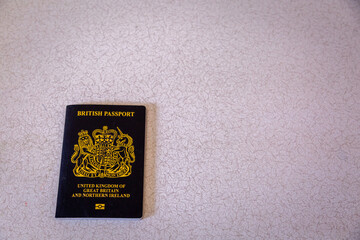 New British passport of post-Brexit blue black UK passport cover with against light background