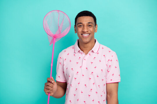 Photo of toothy beaming nice guy dressed casual polo hold butterfly net catching sales on black friday isolated on teal color background