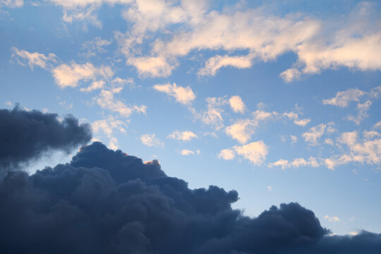 Horizontal photograph of blue clouds in overcast weather at sunset. Aesthetically pleasing neutral photograph. Smoke.