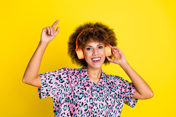 Photo of excited funky woman wear animal print shirt enjoying music headphones pointing finger...