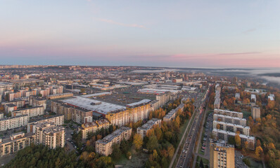 Obraz premium Zirmunai District in Vilnius City, Lithuania. Morning Traffic. Autumn Leaves Color. Morning Golden Hour Light.