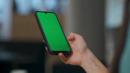 Mockup phone in office woman hands closeup. Worker green screen smartphone