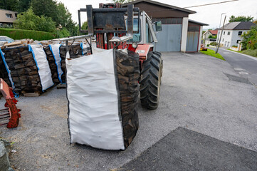 Red tractor  Chopped firewood stacked in large bags, example of a small business  