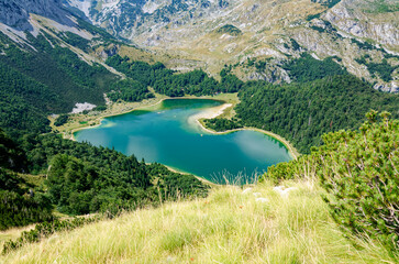 Fototapeta na wymiar View of the heart shaped lake, Trnovacko Lake in Montenegro. Mountaineering lifestyle. Travel and adventurous. Scenic and beautiful view.