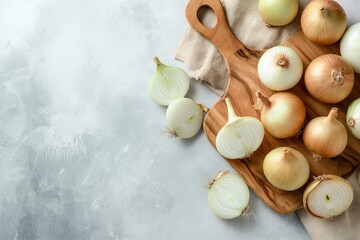 Obraz na płótnie Canvas Composition with wooden board of cut onion on a light background, cut onion on a light background, onion on a cutting board top view, onion slice on a wooden table, onion slice, onion on a marble 