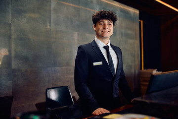 Portrait of happy hotel receptionist looking at camera.