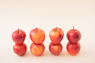 Summer fresh raw apple set on light pastel cream background. Minimal aesthetic.
