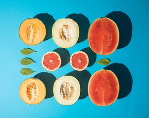 Minimally arranged layout fresh summer fruit on a blue pastel background. Flat lay art.