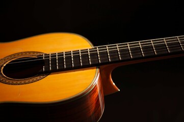 Classical Spanish flamenco guitar close up, dramatically lit isolated on black background with copy space.