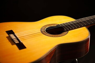 Classical Spanish flamenco guitar close up, dramatically lit isolated on black background with copy space.