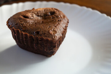 Chocolate cupcake in the shape of a heart on a plate
