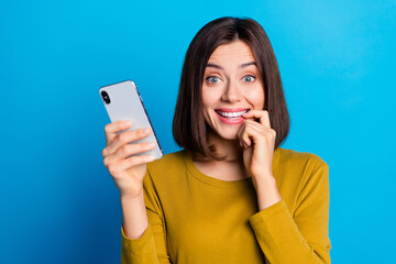 Photo of cunning cute woman wear shirt finger mouth chatting modern gadget empty space isolated blue color background - obrazy, fototapety, plakaty