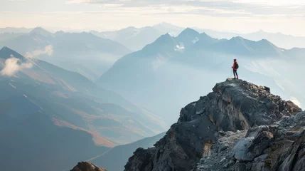 Foto op Plexiglas Hiker standing on mountain peak overlooking vast landscape at dusk. Adventure and exploration concept. © ANStudio