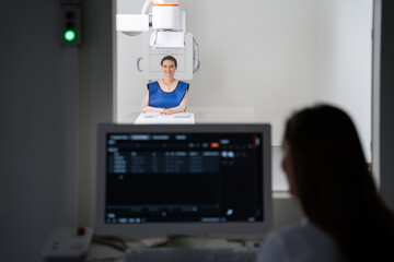 Woman sitting in front of a computer analyzing an xray image - 764259127