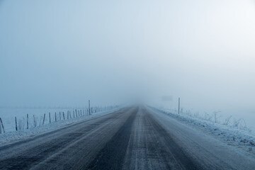 Driving in the winter on icy roads during a winter foggy day. Careful driving in winter conditions....