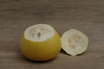 Pomelo fruit with the top of the peel cut off.