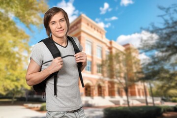 Fototapeta premium Portrait of a young happy student with backpack