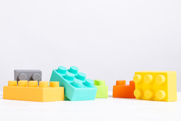 Obraz premium Children's colored blocks, construction set, on white background, copy space. Educational baby toy.