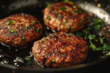 Tuinposter Organic beef hamburger patties with spices in a frying pan. Top view. © Lubos Chlubny