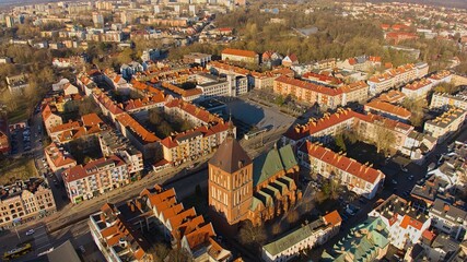 Aerial view of Koszalin city center during the "golden hour" with cathedral, Victory Street, and town hall.