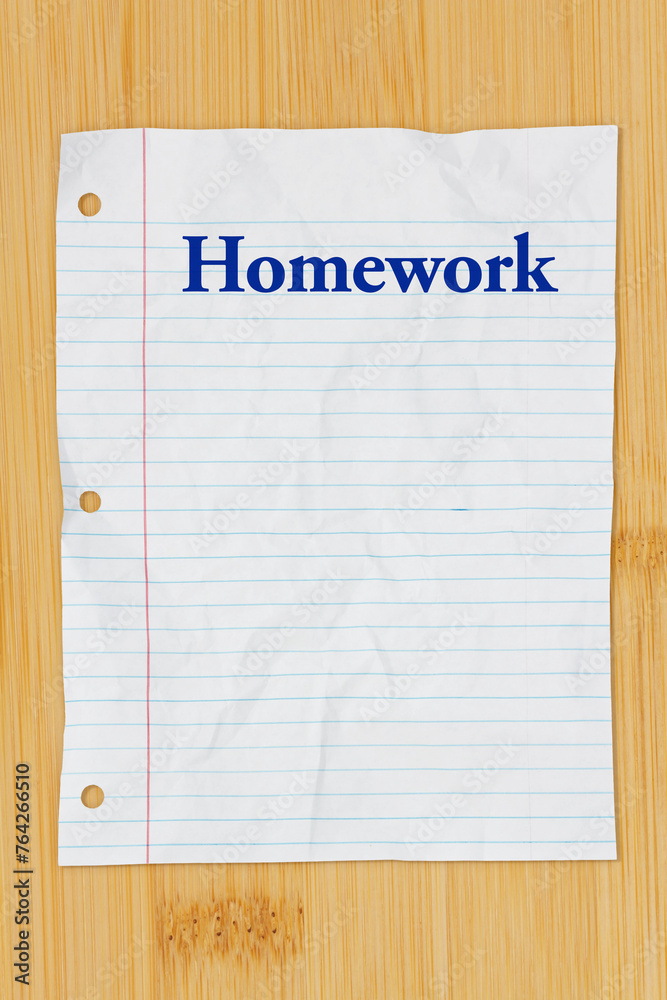 Sticker homework message on crumpled lined rule paper