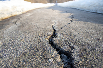  sidewalk in perspective, damage to the road surface in the spring, snow melting on the treadmill,...